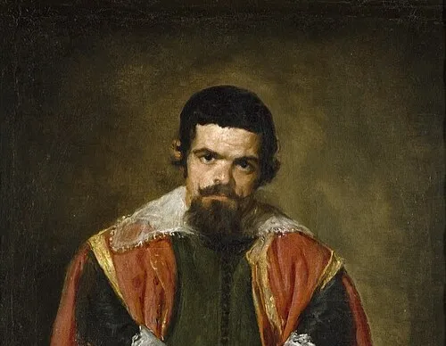 Portrait of a Spanish painter in dark clothing with a red and gold-trimmed cape, representing Diego Velázquez.