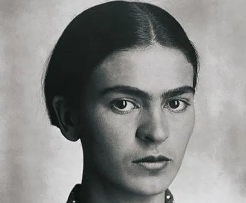 Black and white portrait of Frida Kahlo, Mexican muralist known for large-scale political murals across Mexico and the United States.