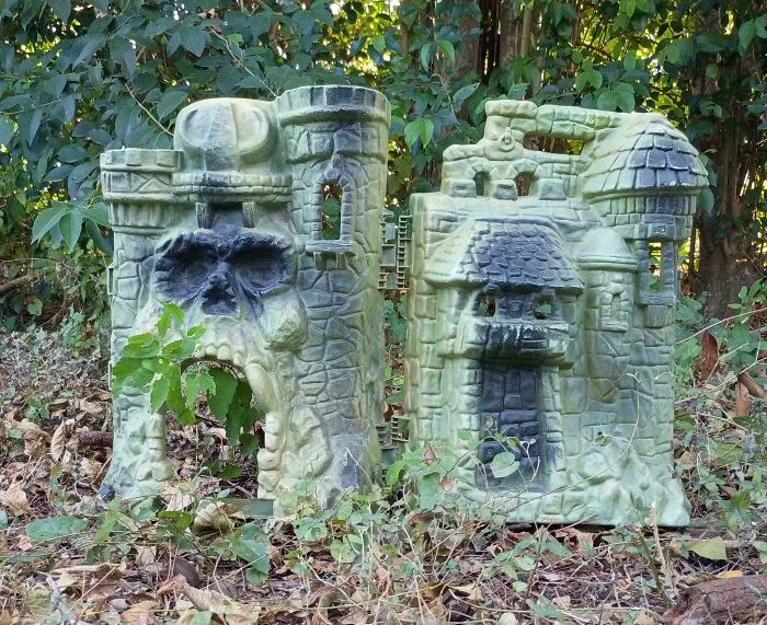 A large, ornate toy castle resembling a skull and other castle features, found during dumpster diving.