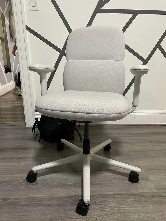 A clean, light grey office chair with white arms and base, found as a lucky dumpster diving find.