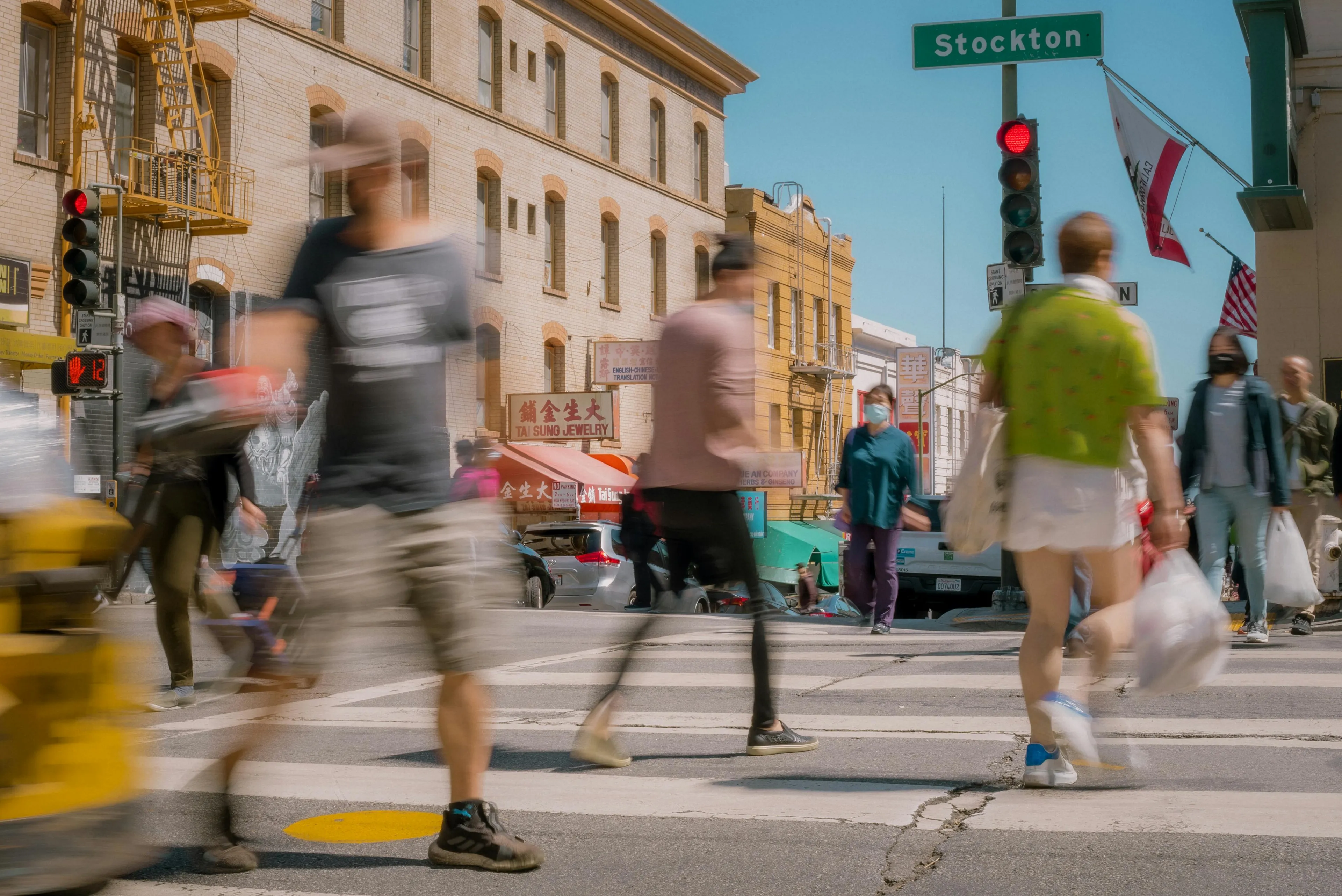 Blurred pedestrians crossing a busy city street capturing everyday scenes in art general knowledge.