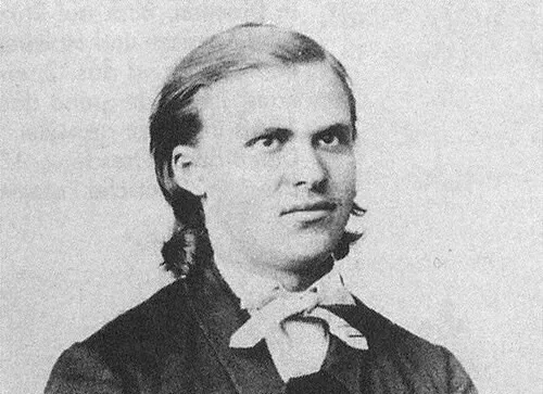 Portrait of philosopher Friedrich Nietzsche in black and white, associated with the concept of Ubermensch.