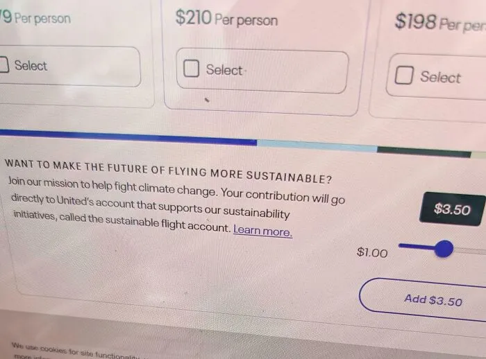 Credit card checkout screen showing a sustainability donation slider highlighting consumerism issues and climate change efforts.