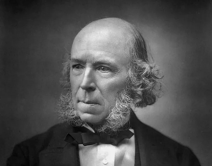 Portrait of Herbert Spencer with distinctive sideburns, representing the phrase survival of the fittest origin.