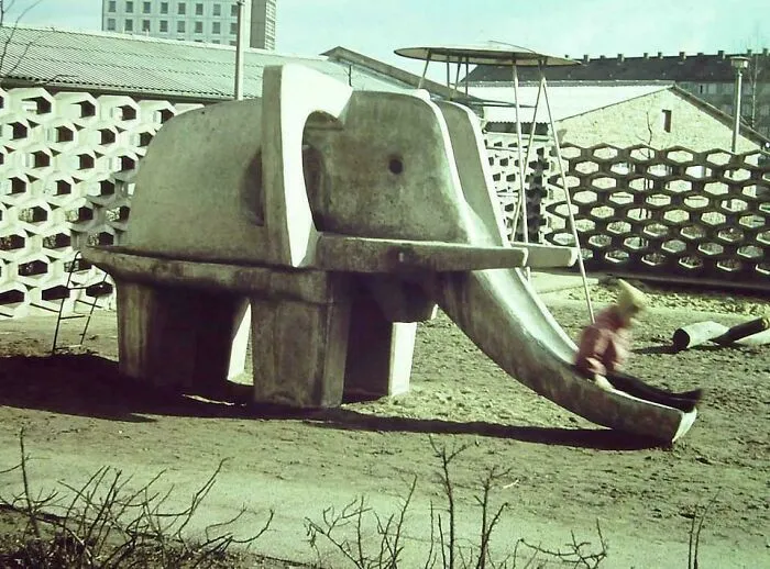 Vintage concrete elephant slide in playground with retro design