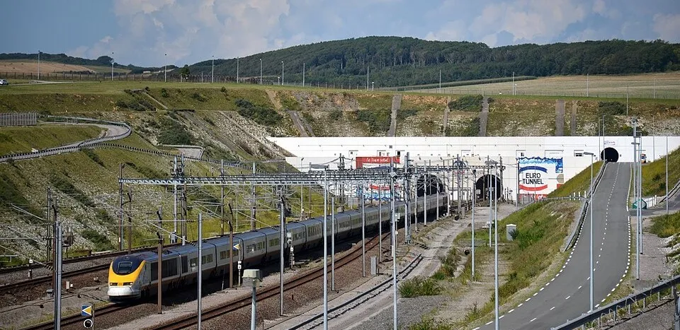 High-speed train approaching the Channel Tunnel entrance connecting England and France through an underground rail passage.