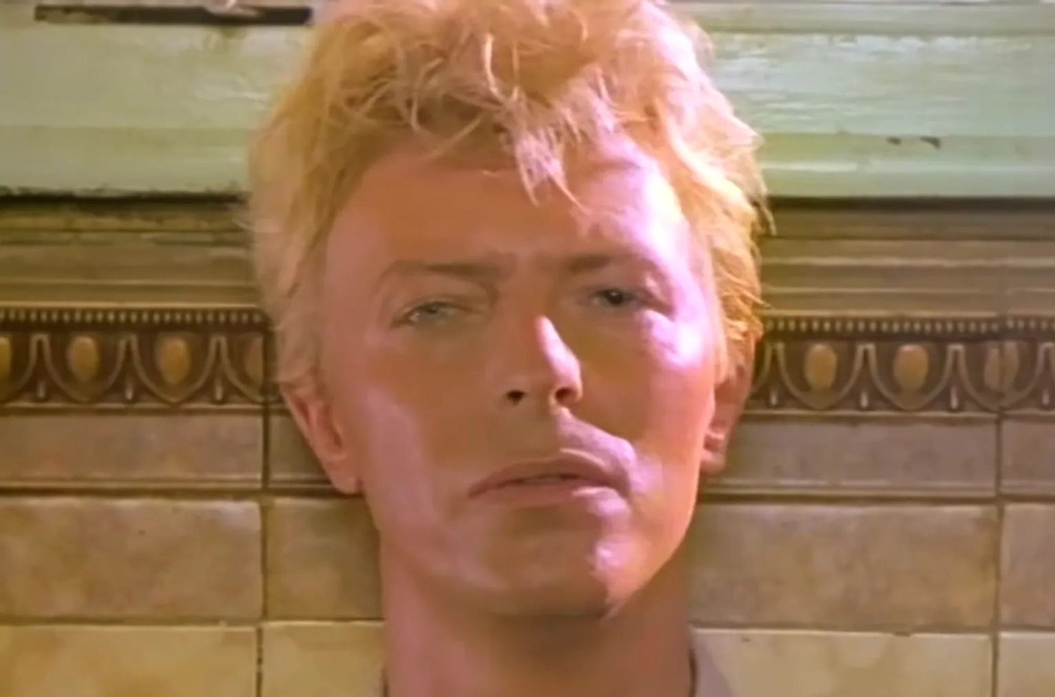 Close-up of a 1980s musician with blonde hair, known for reinventing himself and ruling the 80s music scene.