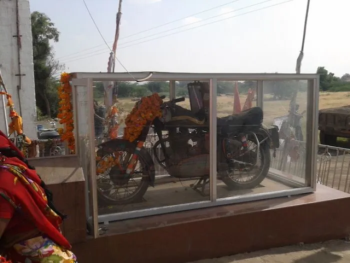 Motorcycle displayed in a glass case at an unusual place featured among unique locations worldwide with Wikipedia pages.