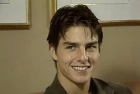 Young 80s actor smiling in a casual setting, embodying the charm of celebs from the 80s sliding into fame.