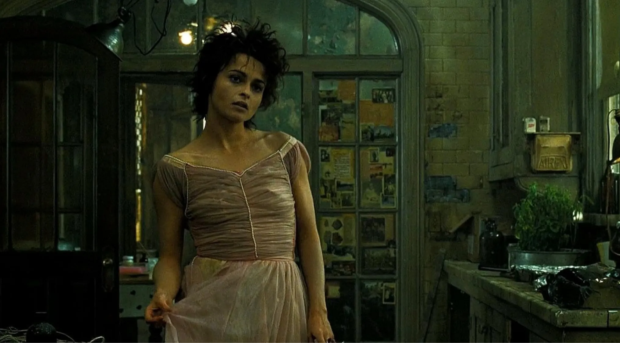 Side character in pink dress standing in dimly lit room with vintage decor in guess the movie from the side character
