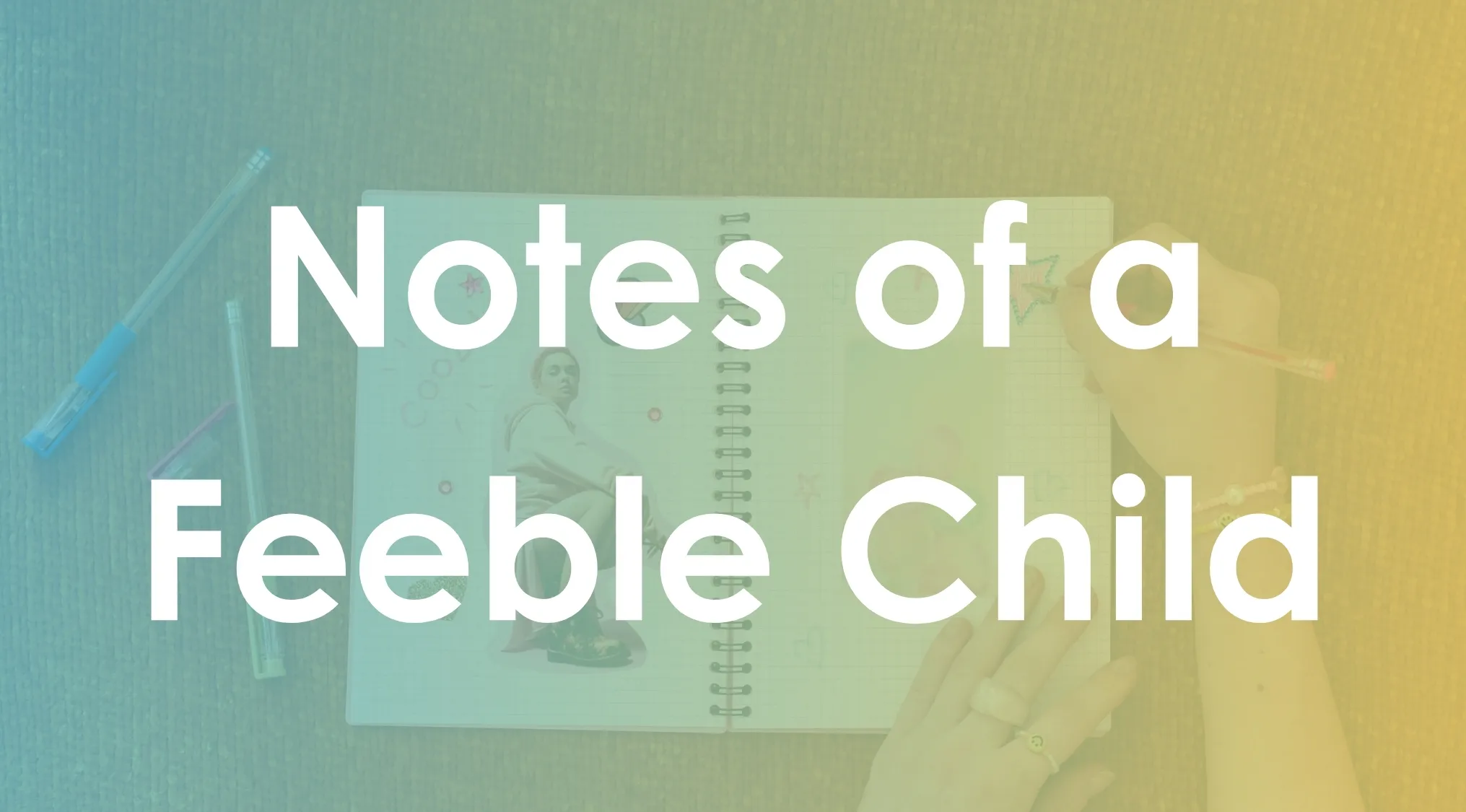 Open notebook with Notes of a Feeble Child title, a person drawing with colored pens on a textured surface.