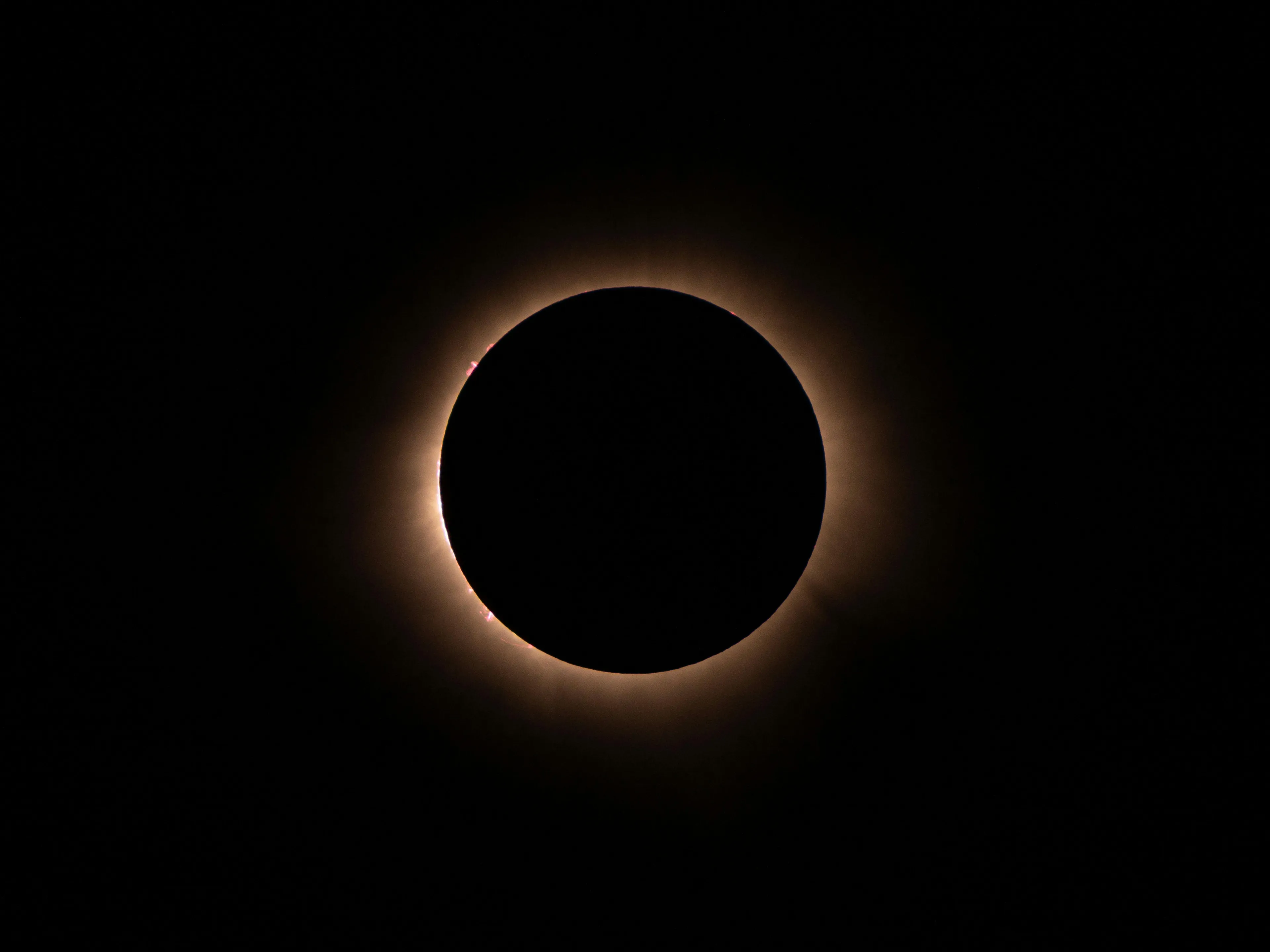 Total solar eclipse showing the Moon blocking the Sun completely during a solar eclipse event at night.