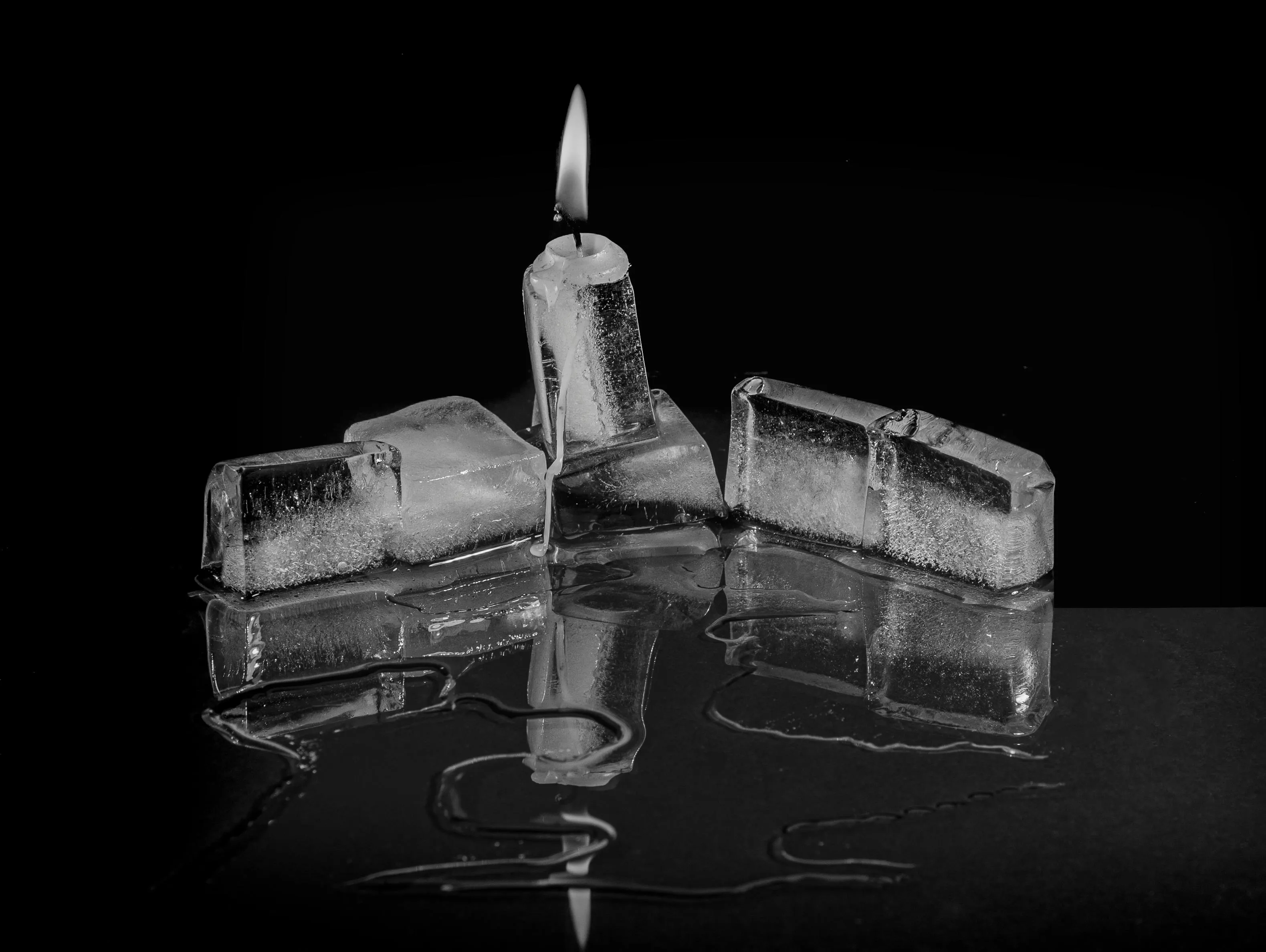 Melting ice cubes turning into water in a warm room illustrating a physical change with chemical composition unchanged.