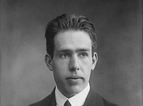 Portrait of physicist Niels Bohr who contributed to the concept of quantized energy and photons in light theory.