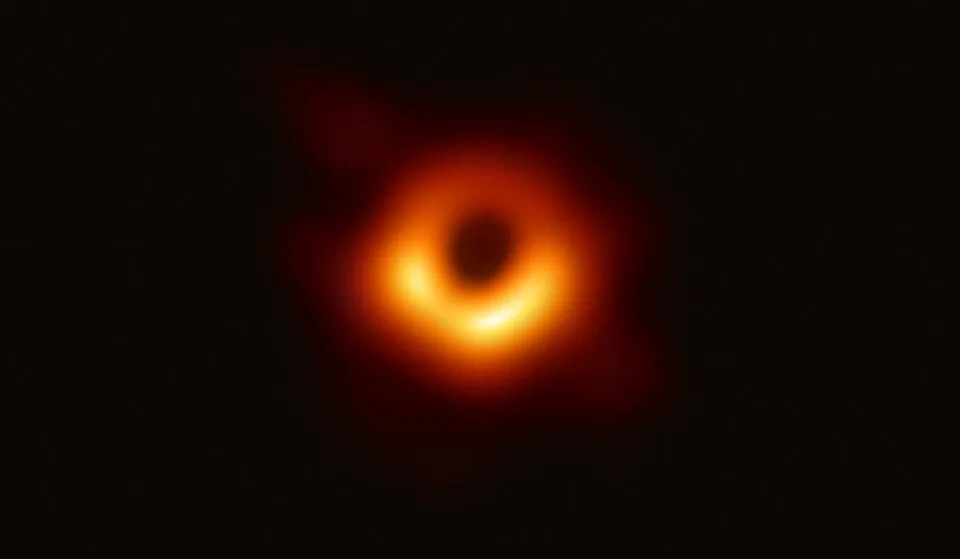 First image of a black hole glowing with bright orange light, related to theoretical physicist Hawking radiation.