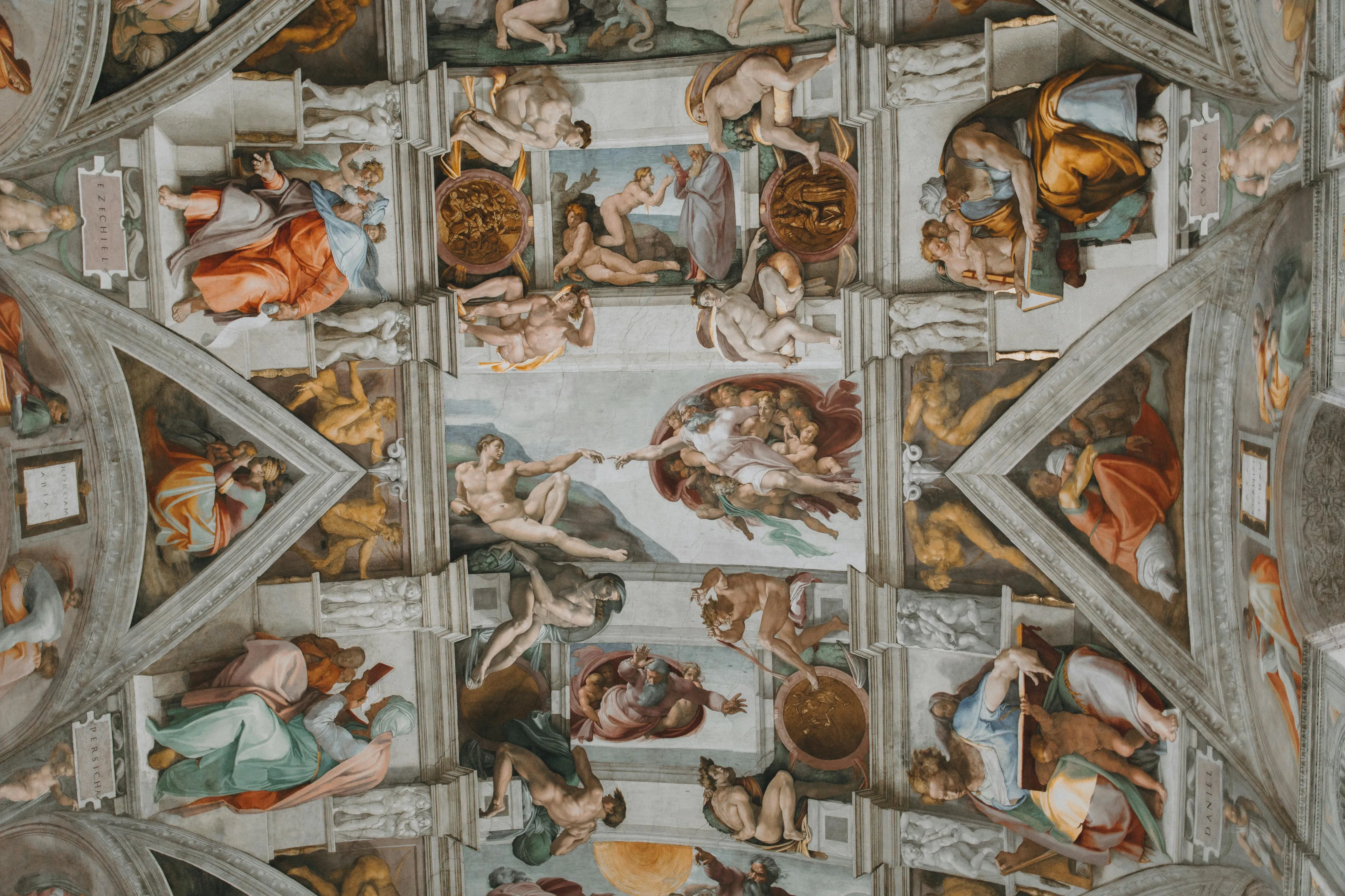 Sistine Chapel ceiling artwork painted by Michelangelo featuring detailed Renaissance frescoes and biblical scenes.