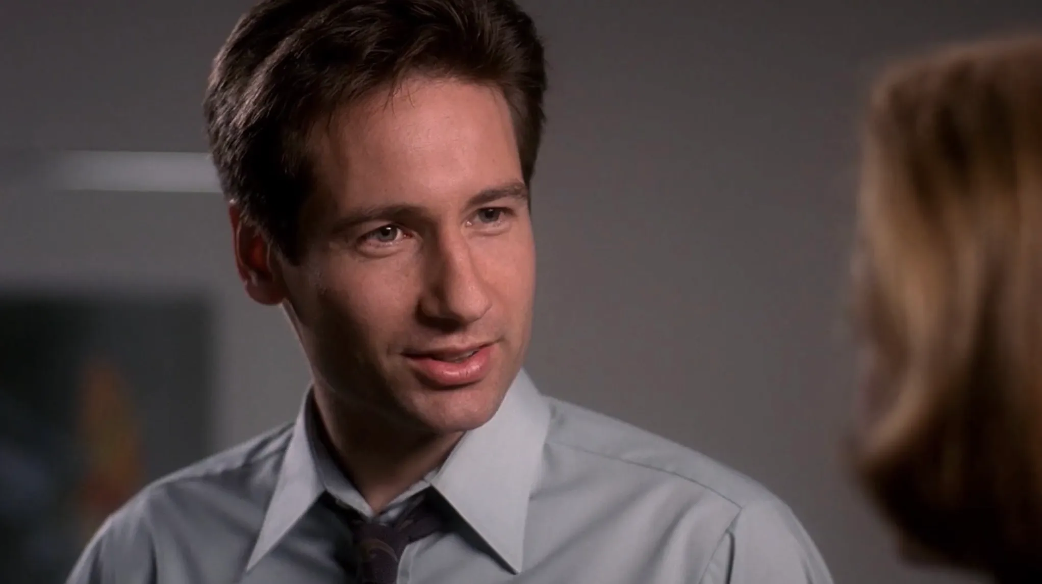 Agent Mulder in The X-Files focusing on proving paranormal and unsolved cases with intense determination.