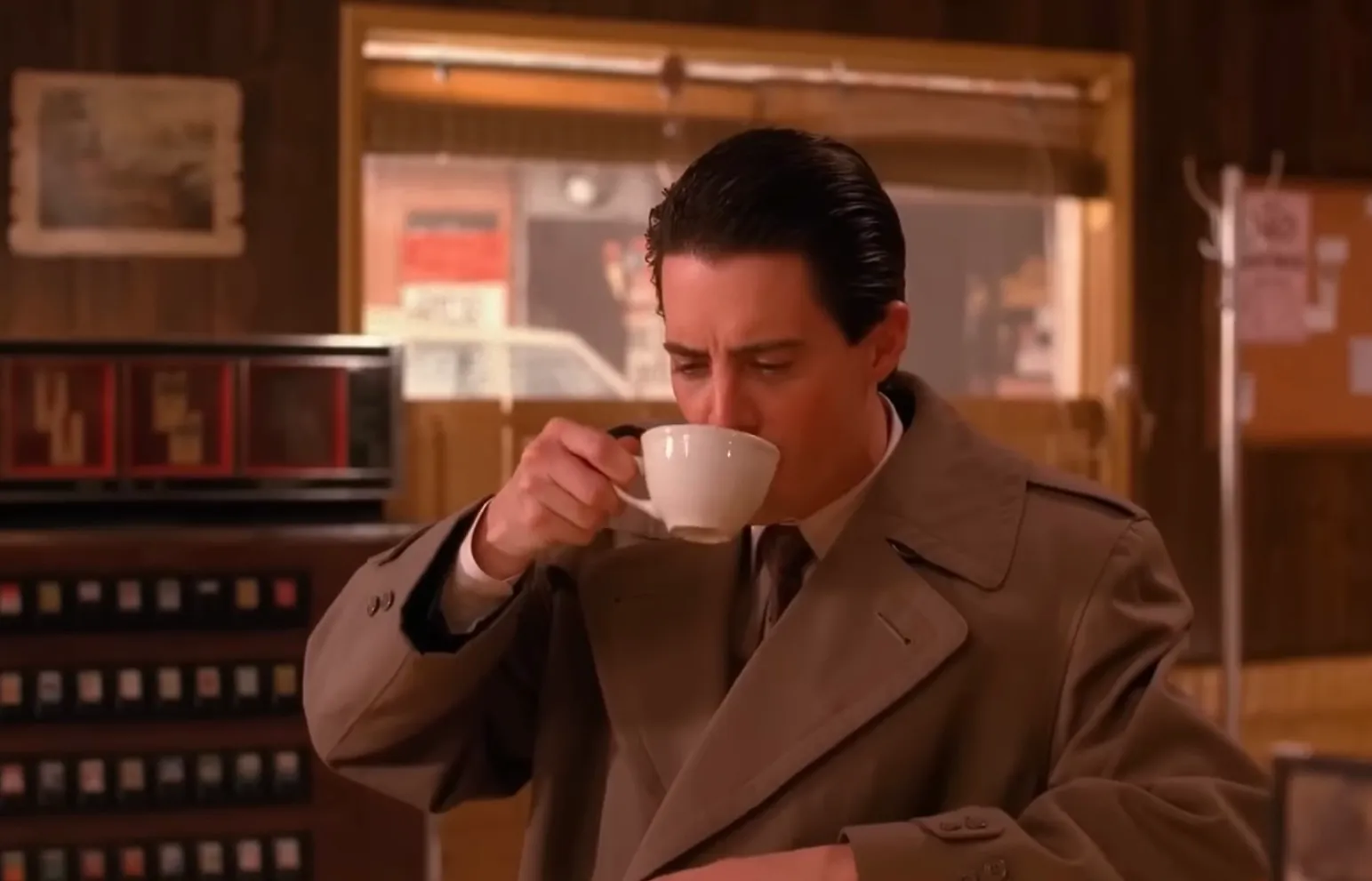 Agent Dale Cooper drinking coffee in a diner scene from the mystery drama investigating Laura Palmer’s case.