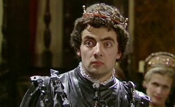 Rowan Atkinson dressed as a king in a historical comedy, representing multiple time periods from 80s and 90s TV knowledge.