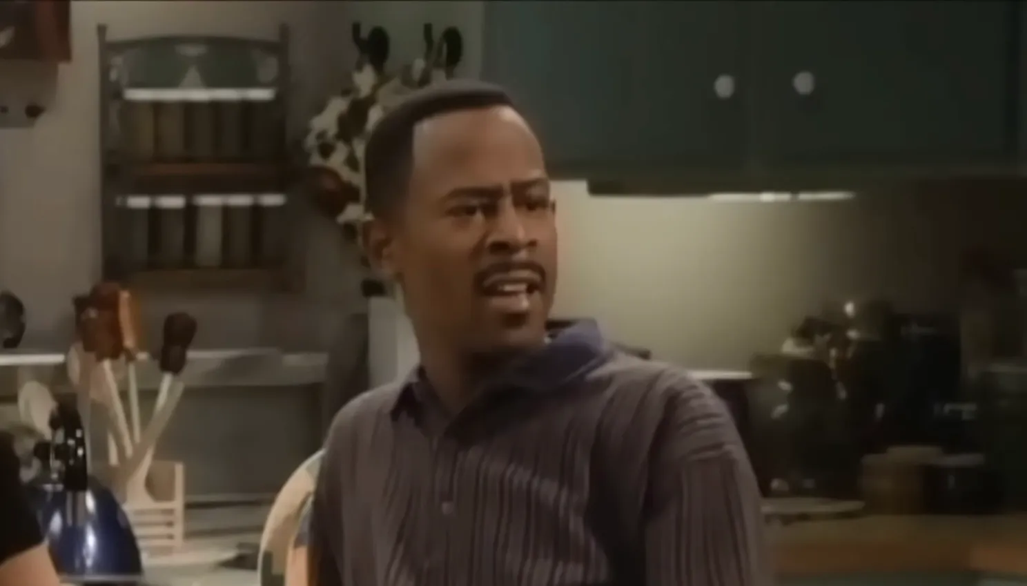 Martin Payne from sitcom Martin reacting with a confused expression in a kitchen setting from 90s TV knowledge.