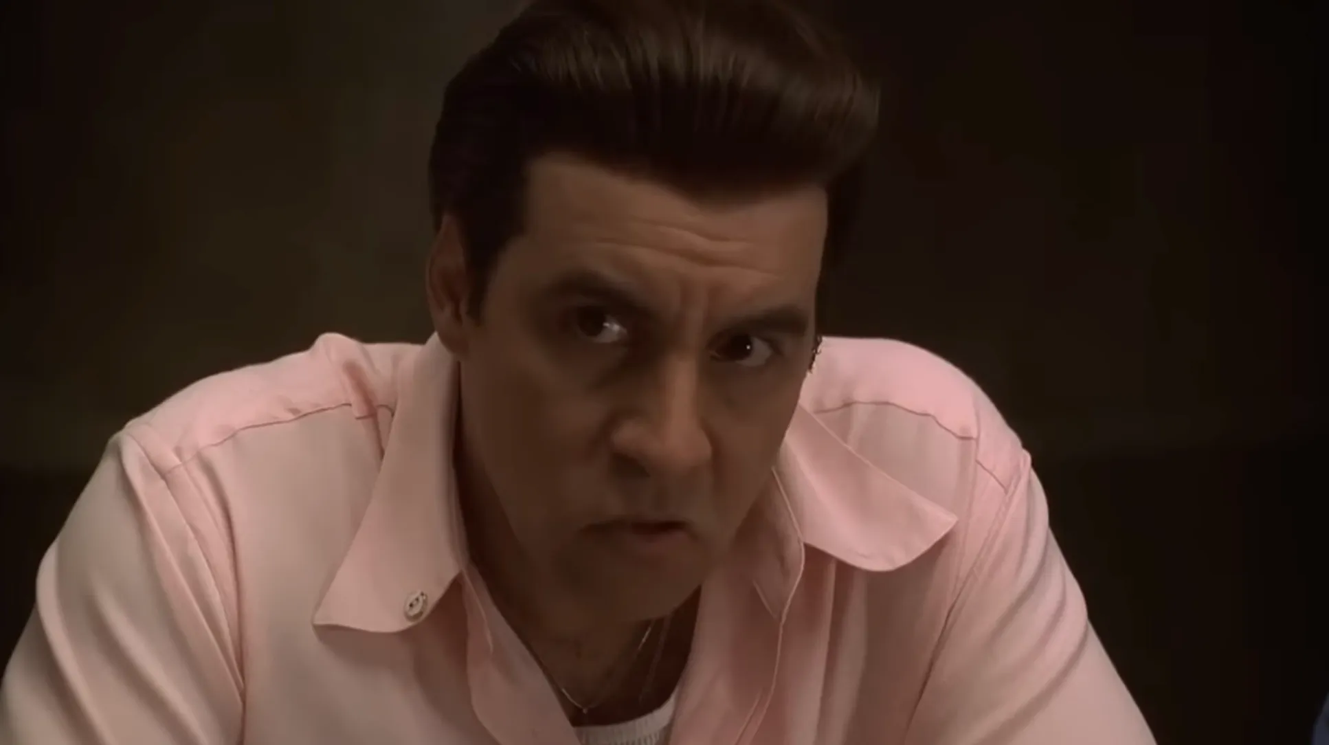 Silvio Dante from The Sopranos in a pink shirt, showing concern while balancing family life and crime organization roles.