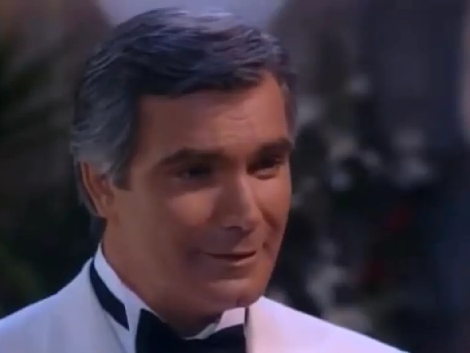 Eric Forrester from The Bold and the Beautiful wearing a white tuxedo jacket and black bow tie in a close-up scene.