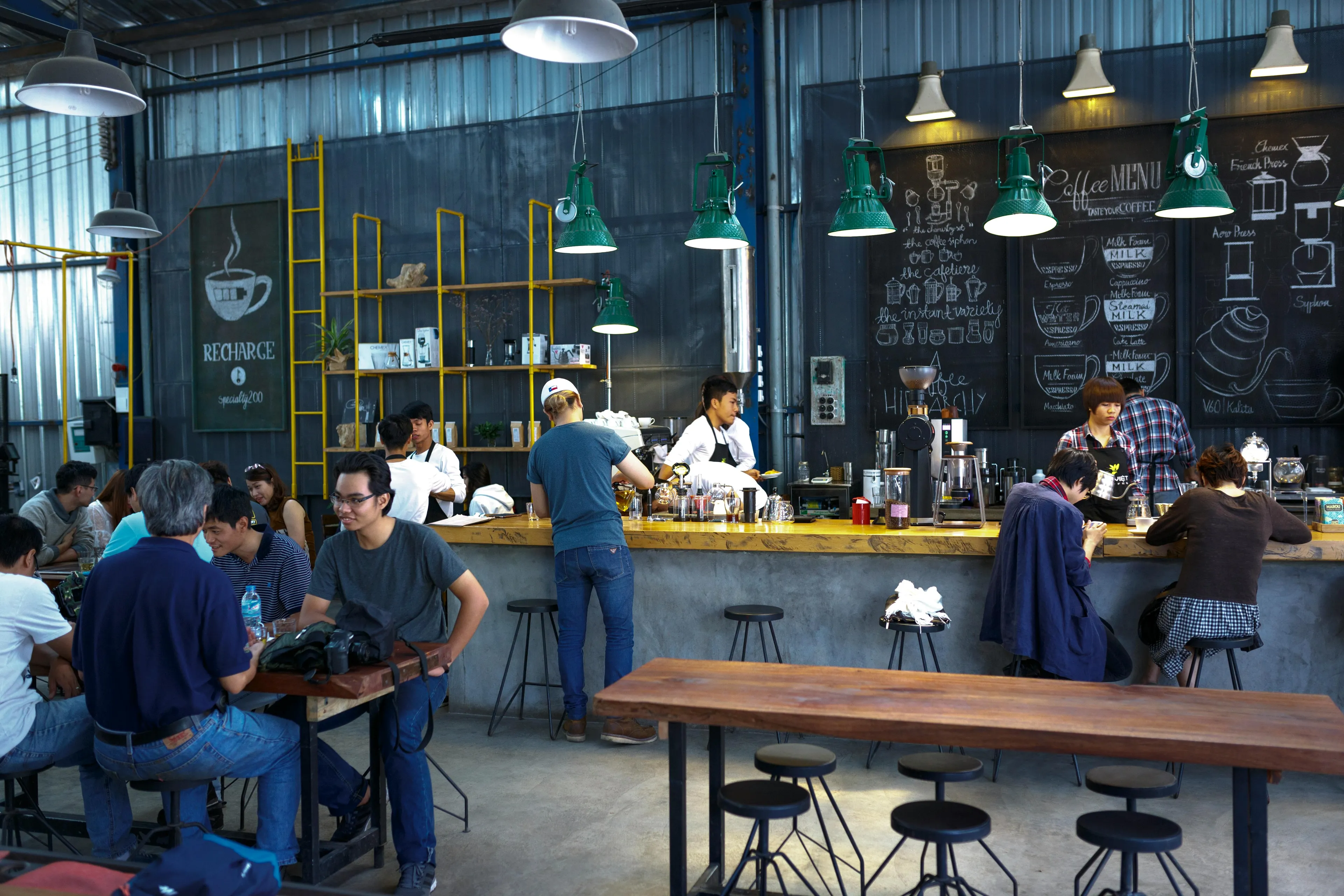 Customers choosing seats in a crowded coffee shop, illustrating behavior on the narcissism scale in social settings.