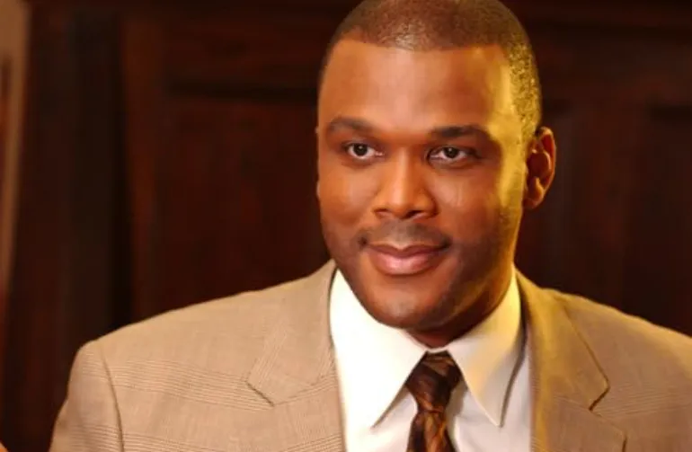 Headshot of a man in a beige suit and tie, representing the face of the Mission Impossible film franchise.