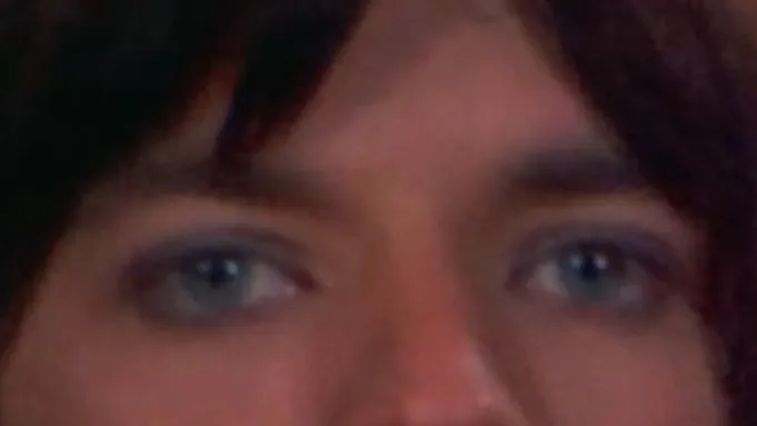 Close-up of celebrity eyes with blue irises and dark hair, focusing on the unique details of these peepers.