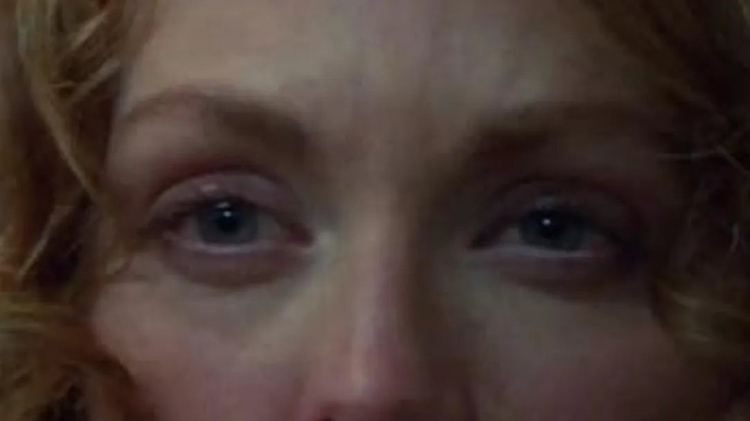 Close-up of a woman’s eyes with curly hair, highlighting the intense celebrity eyes staring directly ahead.