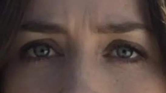 Close-up of celebrity eyes with intense gaze and natural makeup, highlighting unique eye color and expression.
