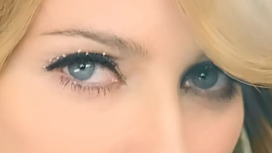 Close-up of celebrity eyes with blue irises and shimmering eye makeup, highlighting the focus on celebrity eyes.