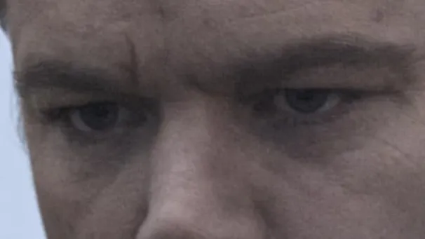 Close-up of celebrity eyes showing intense gaze with deep wrinkles and shadowed skin texture around peepers.