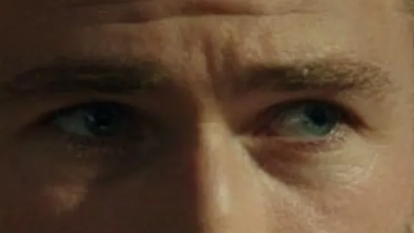 Close-up of celebrity eyes making strong eye contact, focusing on intense gaze and facial expression.
