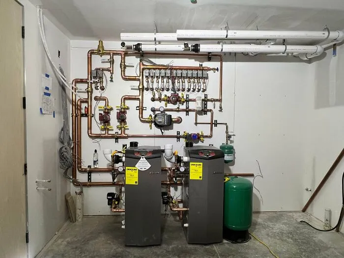 Industrial equipment with complex piping system in a utility room, illustrating unusual autopsy findings even doctors found strange.