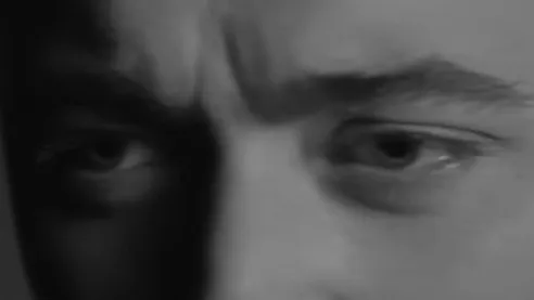 Close-up of a person's eyes showing intense expression, part of a celebrity eyes guessing game.