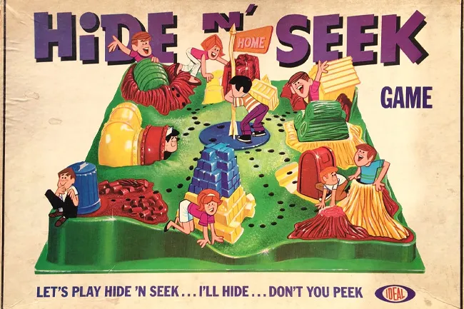 Vintage Hide and Seek board game with children hiding and seeking around colorful play structures on a green game board.