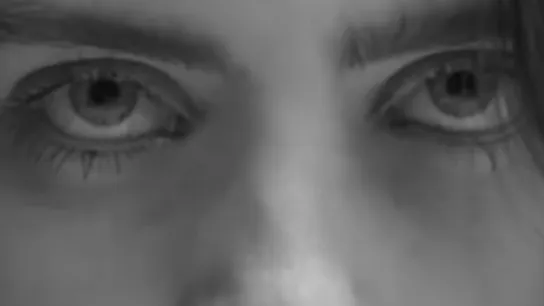 Close-up of celebrity eyes with blue hair, showing detailed eye expression and natural eyebrows.