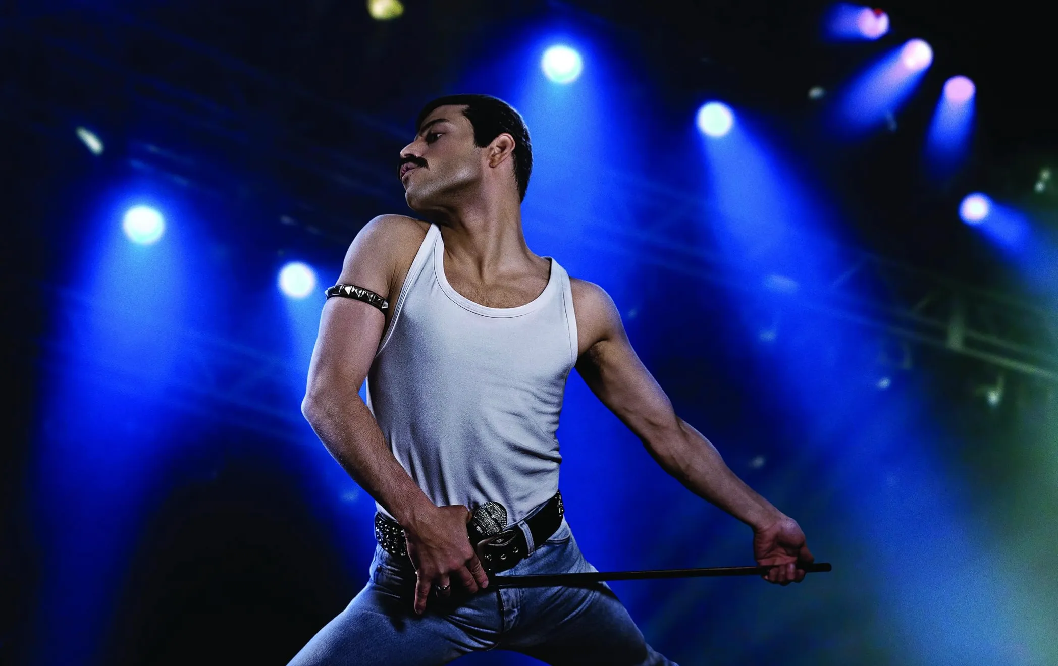 Actor portraying a famous person on stage with dramatic lighting, capturing the essence of a renowned film character.