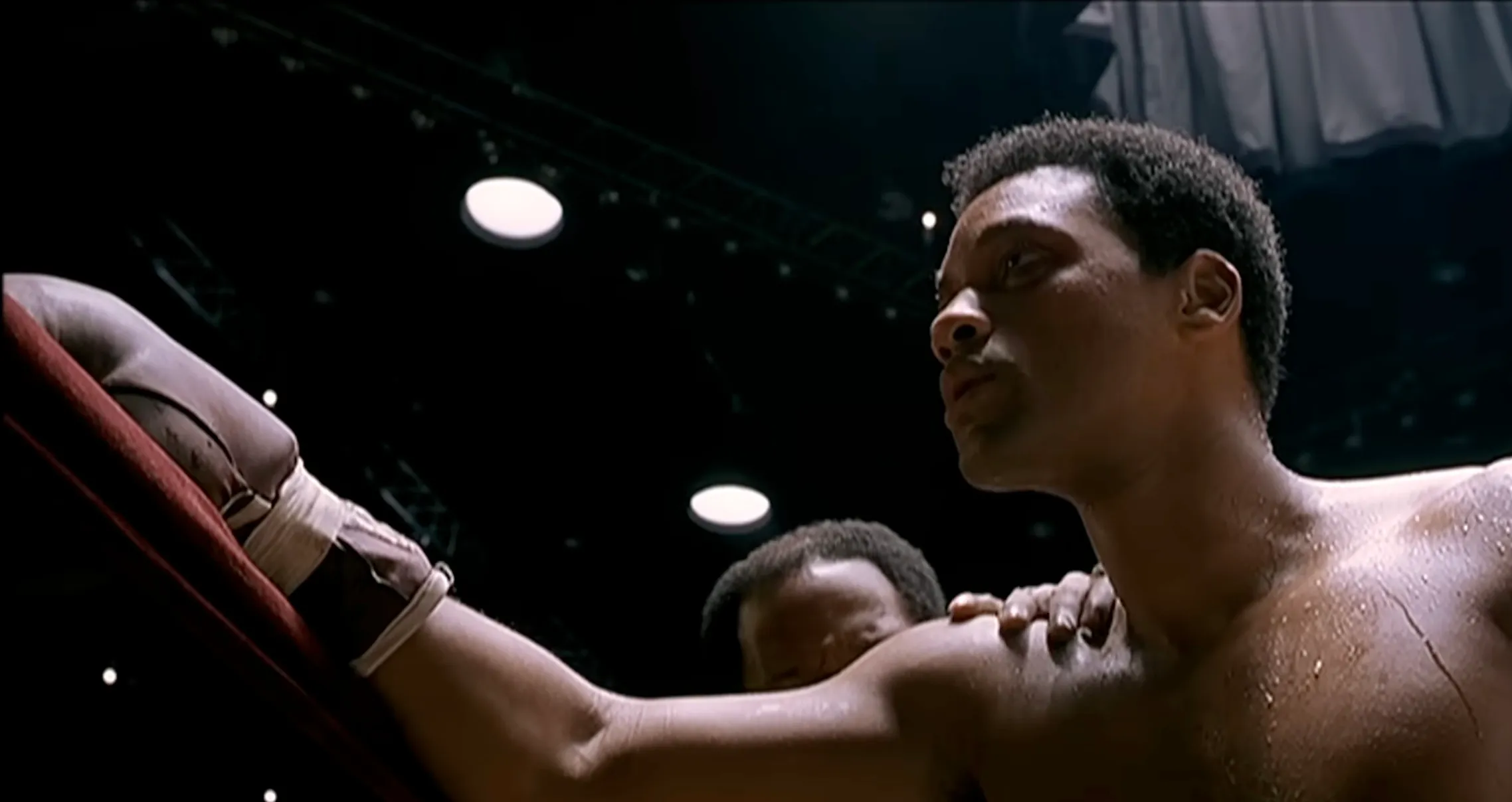 Boxer on screen during intense scene in 2001 movie, portraying strength and determination in the ring.
