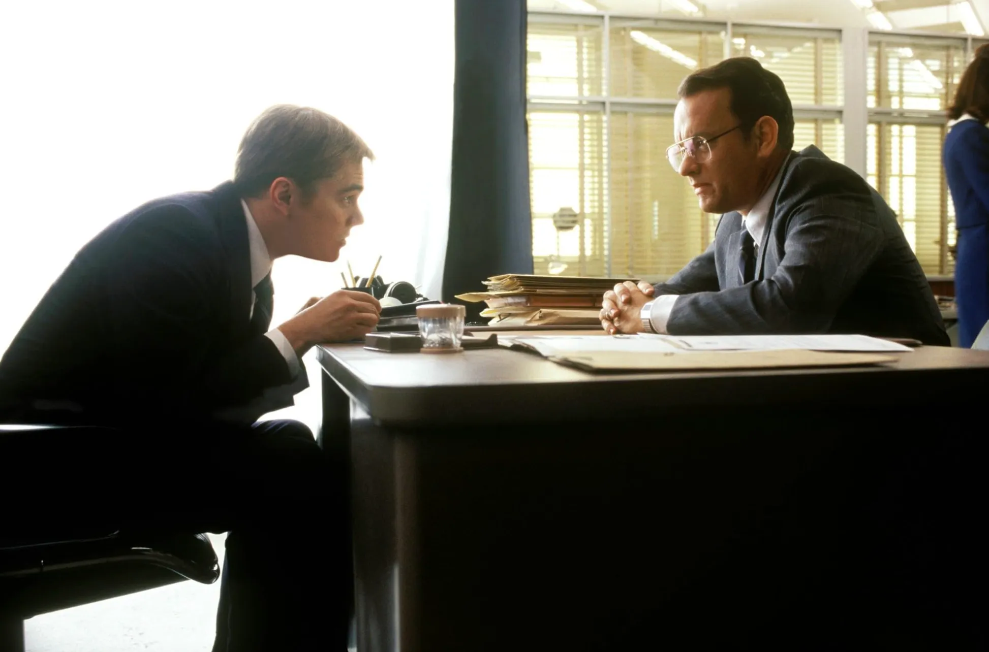 Leonardo DiCaprio and Tom Hanks in Catch Me If You Can, depicting the skilled con artist and pursuing FBI agent.