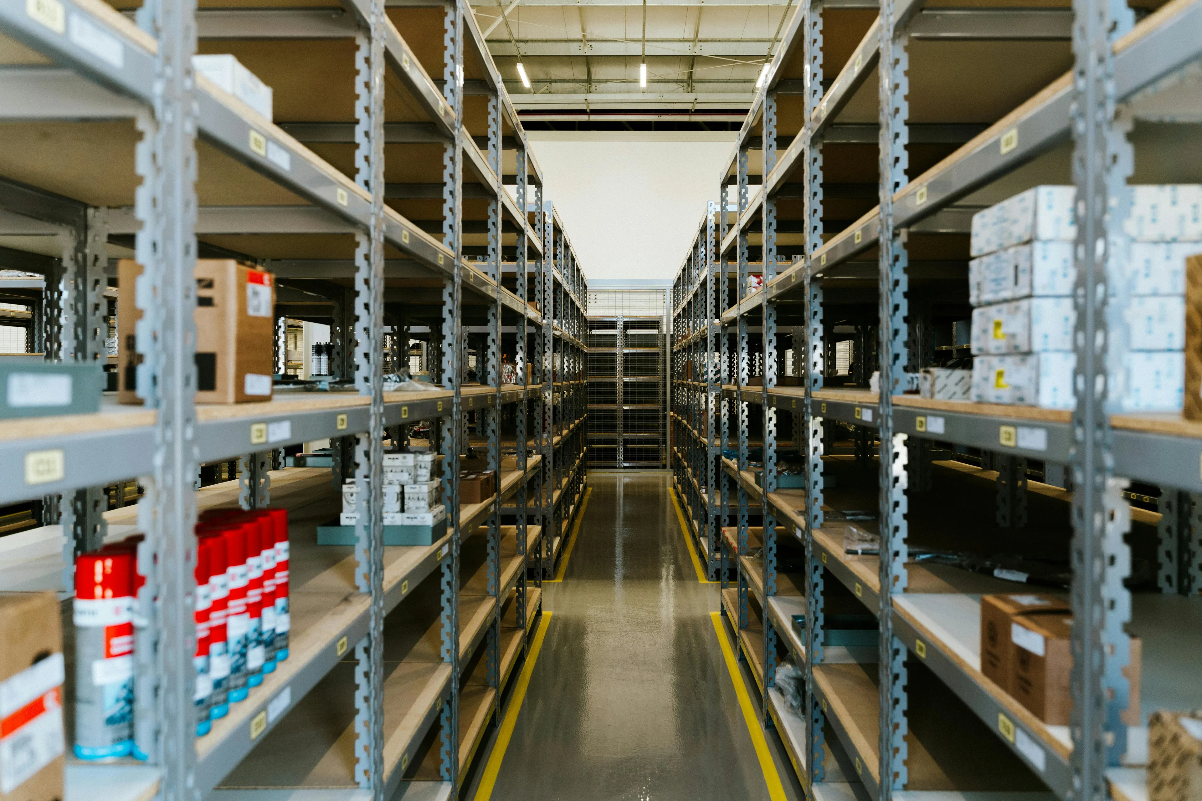 Warehouse shelves with limited stock illustrating supply in economics when demand increases but supply stays the same