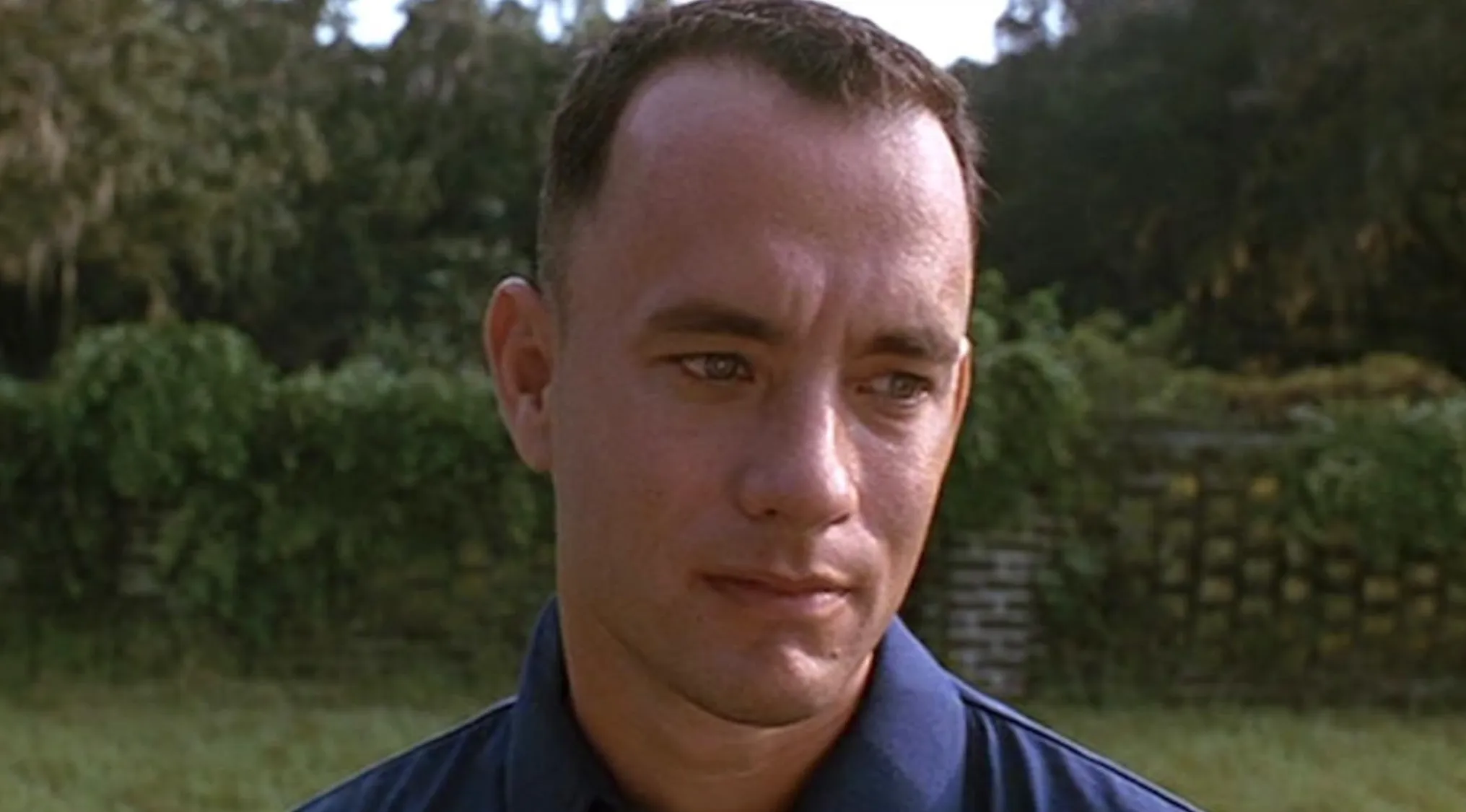 Close-up of a man outdoors with greenery in the background for the movie taglines quiz about Forrest Gump promotion.