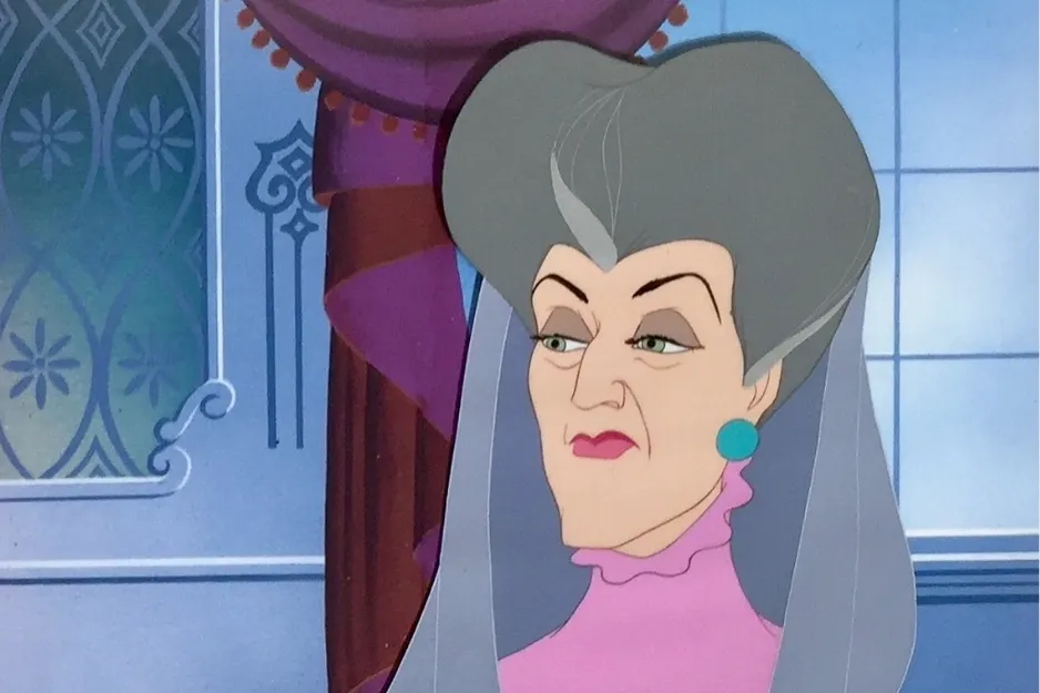 Lady Tremaine, a fashionable villain obsessed with fur coats, looking displeased in a royal interior setting.
