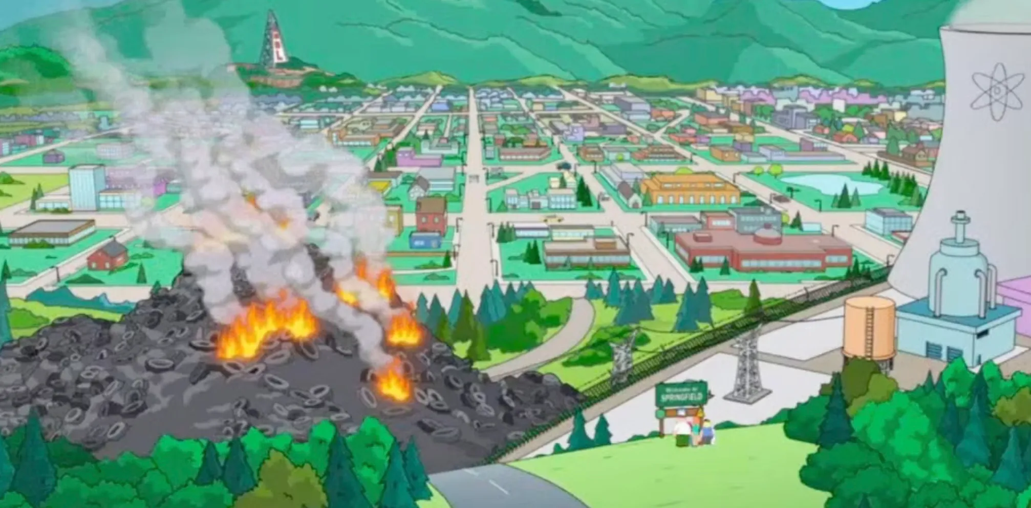 View of Springfield from The Simpsons, featuring the nuclear power plant, burning tire pile, and surrounding town landscape.