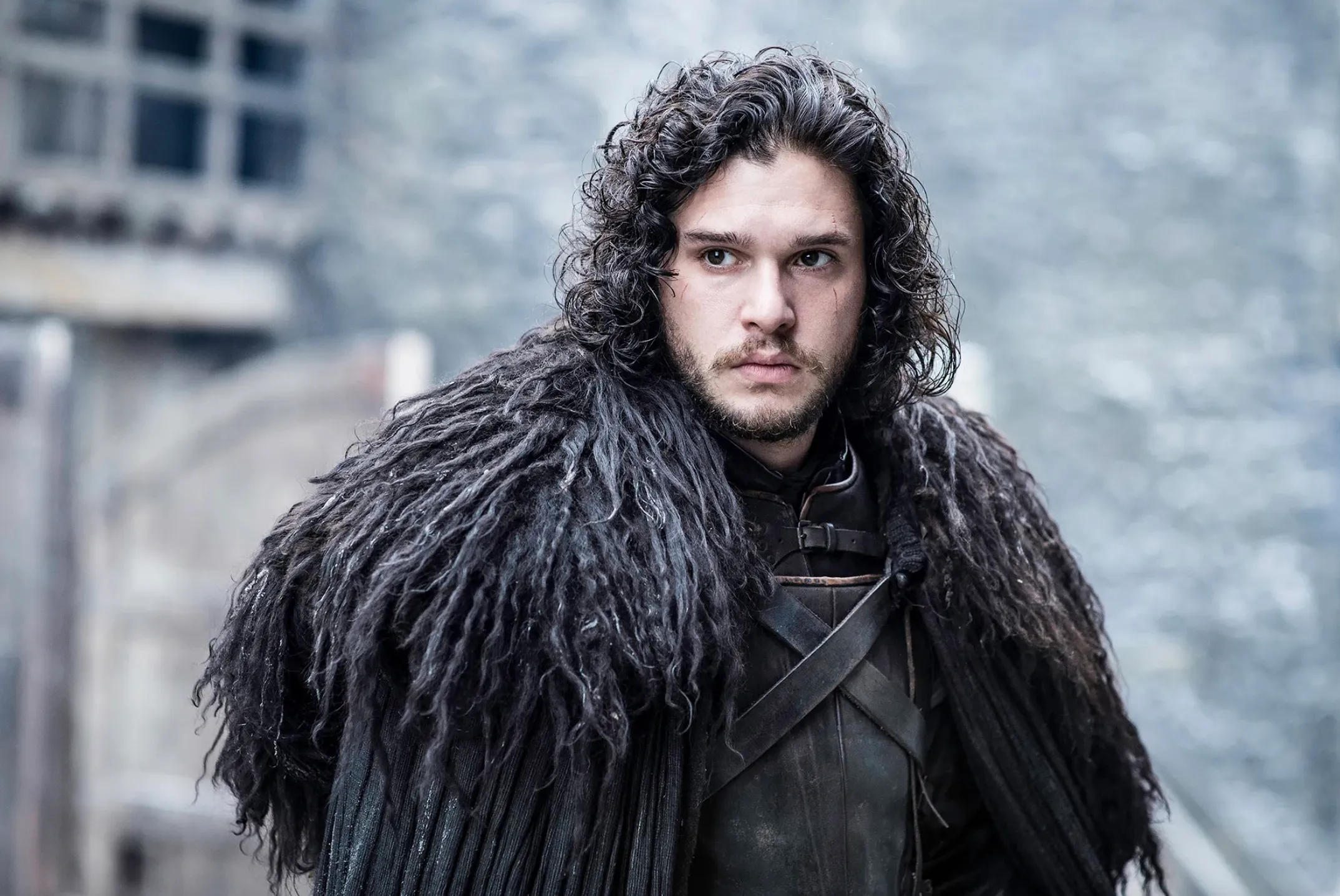 Character resembling Jon Snow standing outdoors in dark fur cloak, not related to Nevermore Academy studies or characters.
