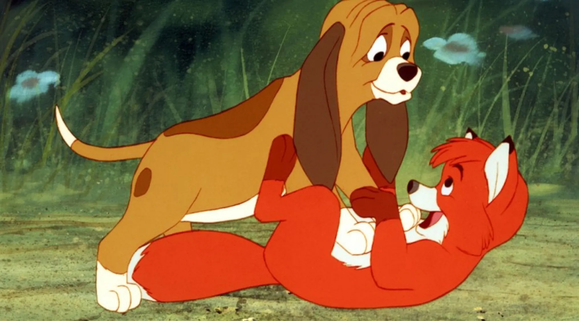 Young Disney characters Tod the fox and Copper the hound playing together in a forest scene from The Fox and the Hound.