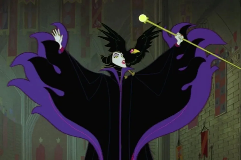 Maleficent in a dramatic pose with a raven on her shoulder and a staff, wearing a black and purple cloak inside a castle.