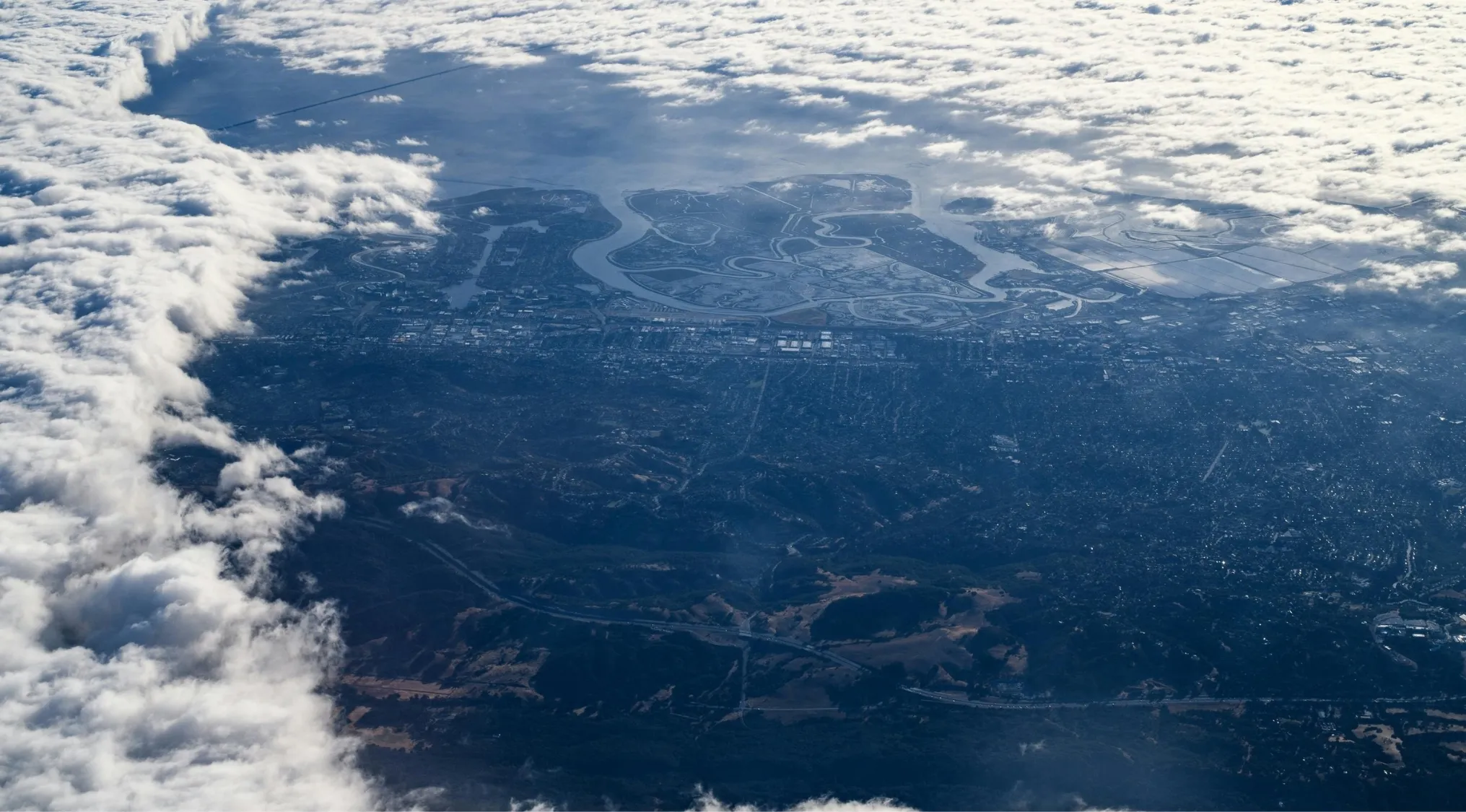 Aerial view of a foggy cityscape with winding rivers, highlighting the world's highest capital by elevation.