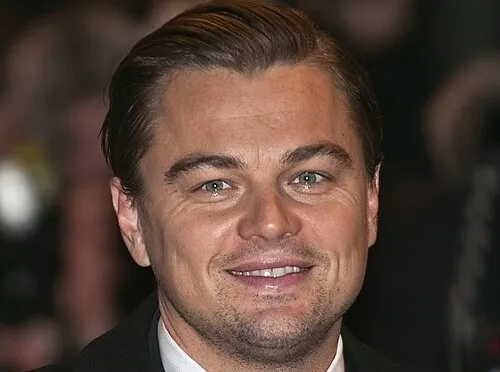 Close-up of Leonardo DiCaprio smiling at a public event, related to actor playing Captain Jack Sparrow query.